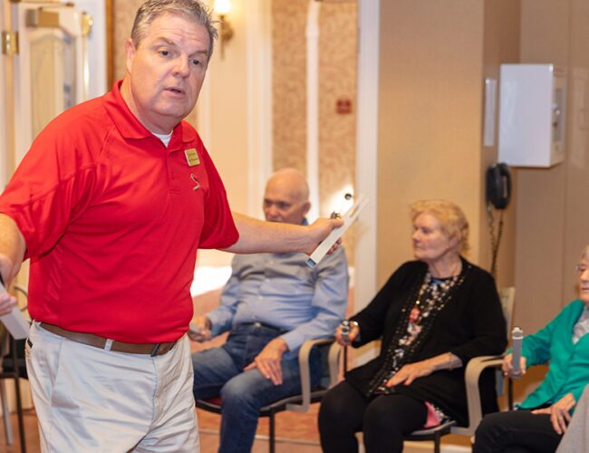 Preview image of a man in a red shirt leading activity