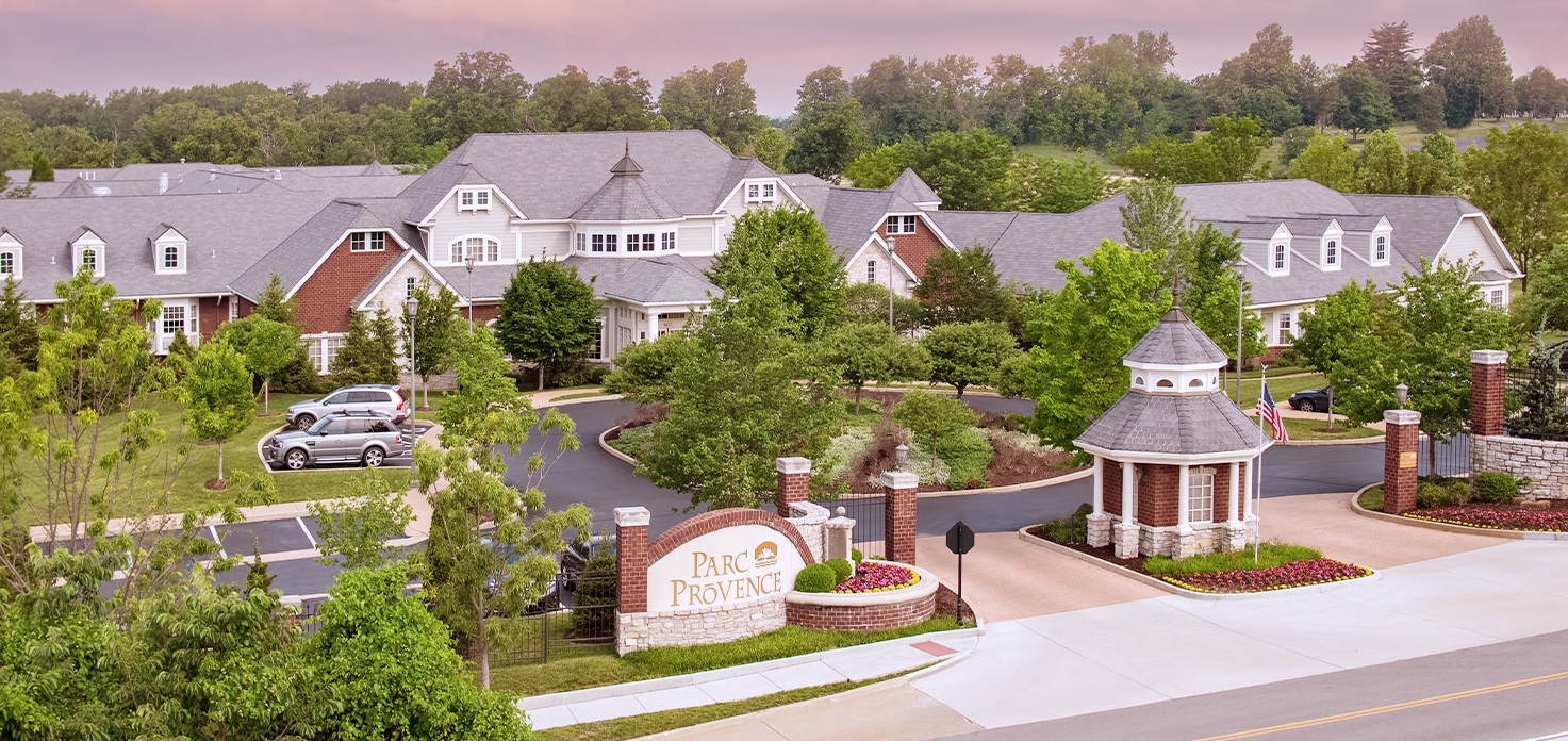 Wide angle view of the front of Parc Provence, with monument sign.