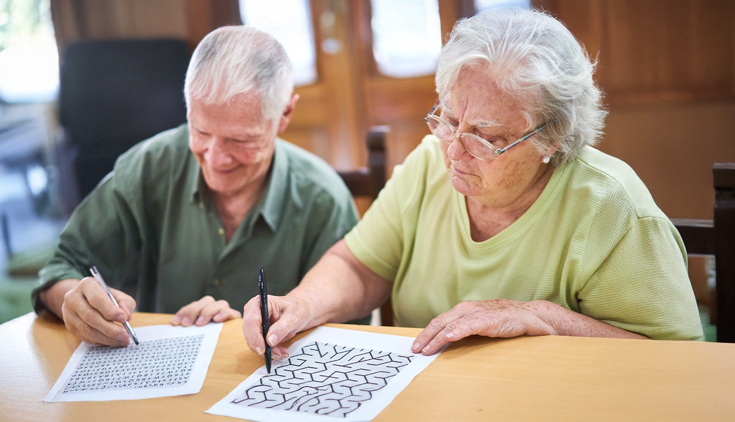 seniors filling out puzzles on paper