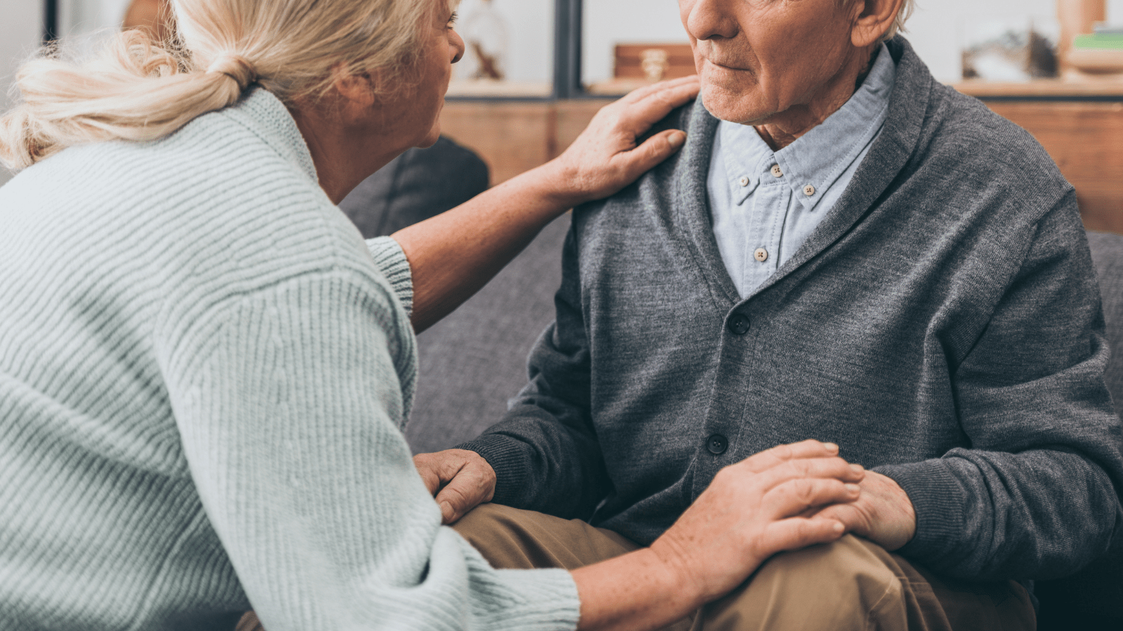 A woman comforts and older man.