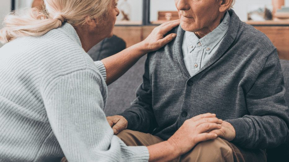 A woman comforts and older man.