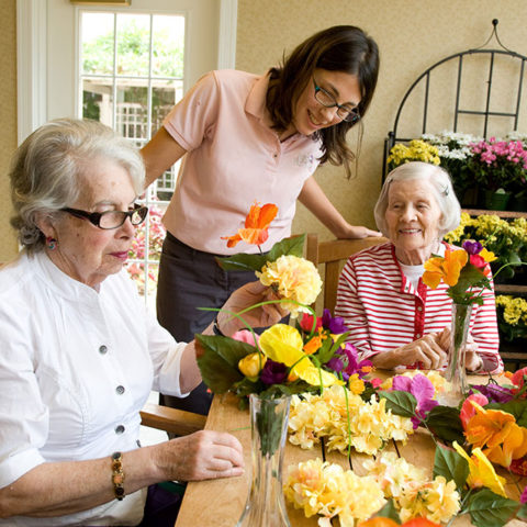 Caregiver with memory care residents who show surprise