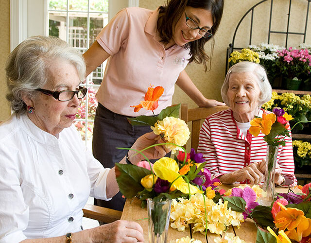 Caregiver with memory care residents who show surprise