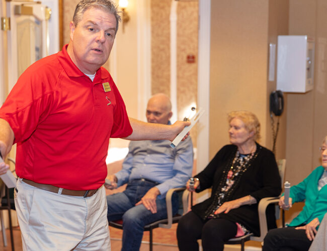 Preview image of a man in a red shirt leading activity
