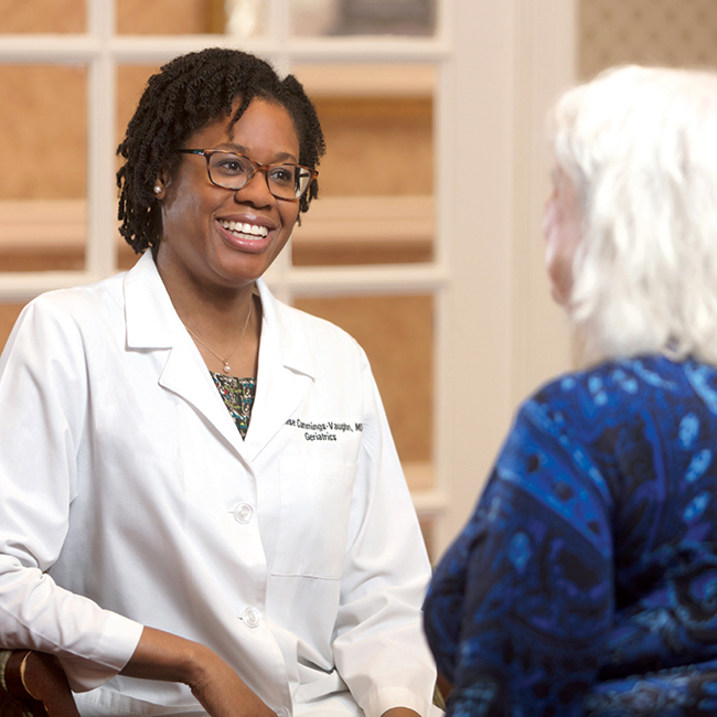 Doctor speaking with a woman in a blue sweater