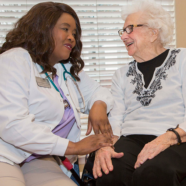 Two women embracing and talking