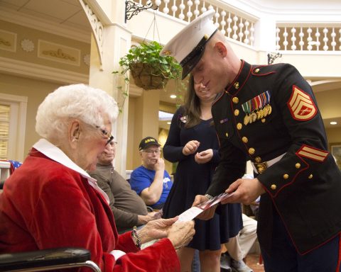 Staff Sergeant Joshua Jacobs interacting with a female resident