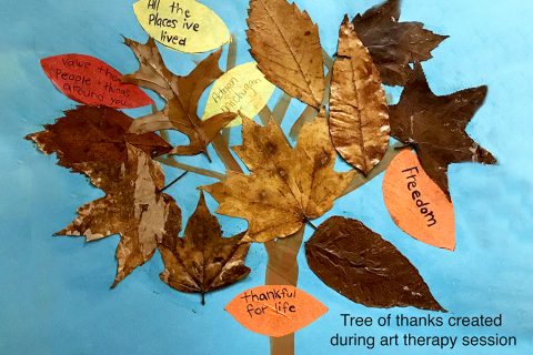Resident artwork of a tree with real leaves glued on