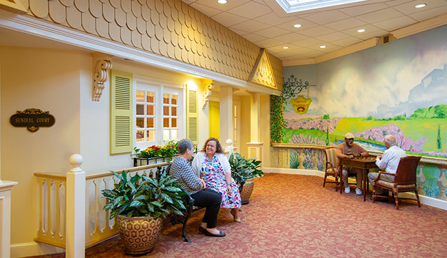Residents and caregiver spending time in the village court.